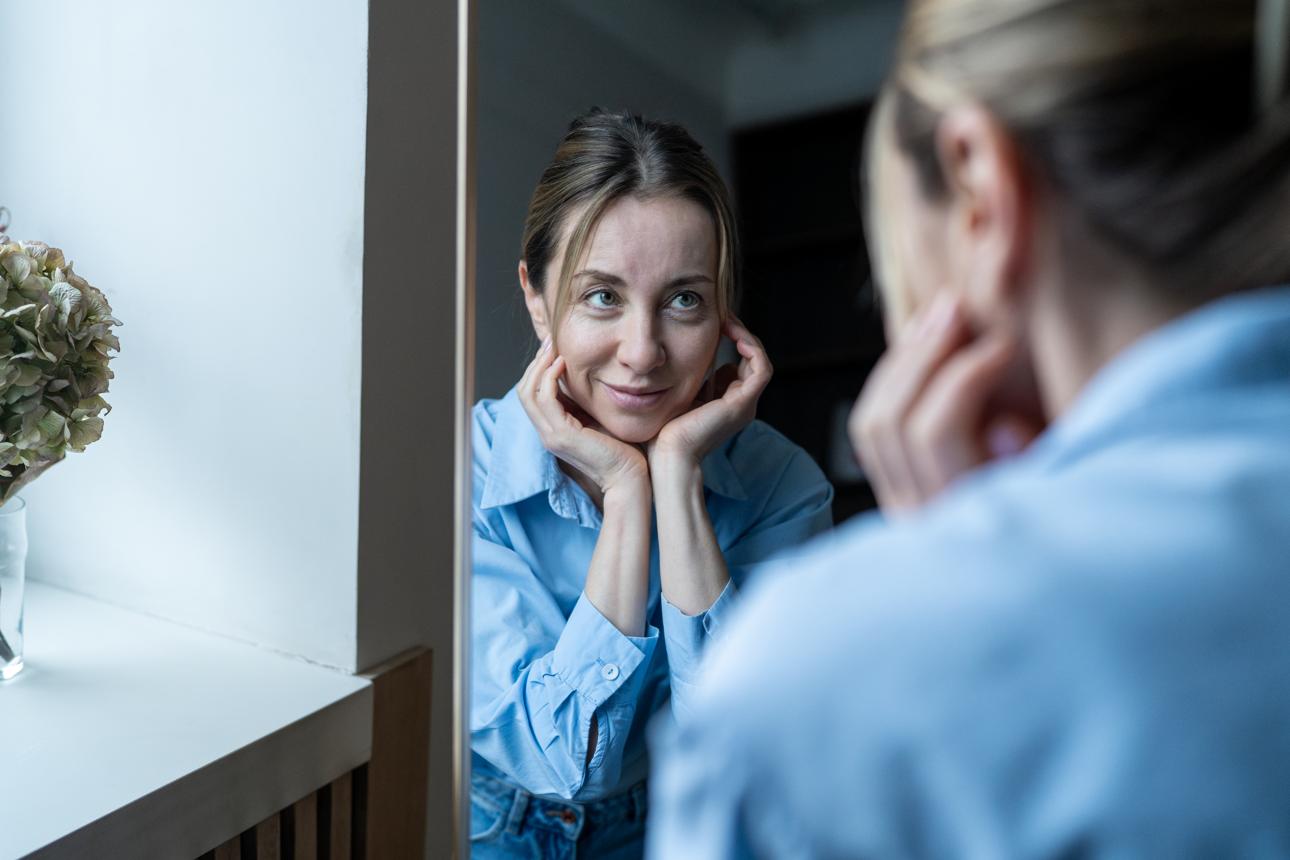 woman looking in the mirror