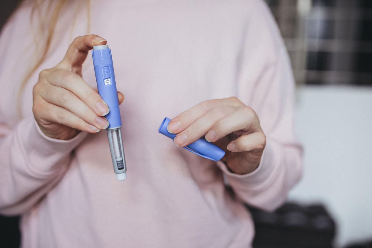 woman holding pen needle