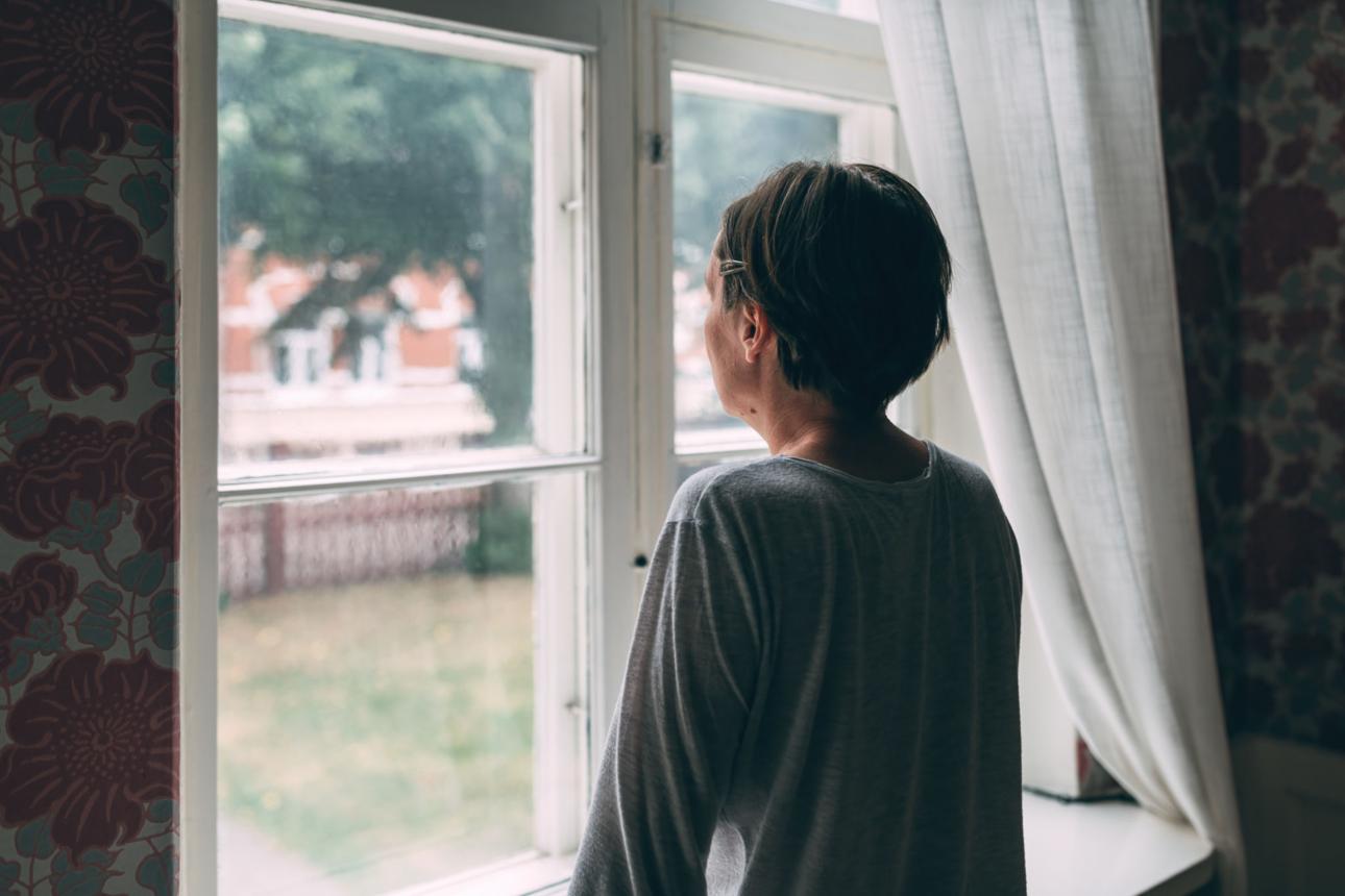woman looking out the window